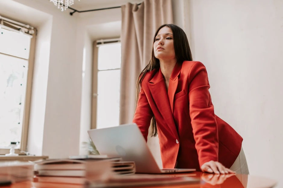 A confident person smiling while reviewing their financial plan on a laptop.